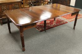 An early Victorian extending dining table with four leaves, fully extended 209 cm,