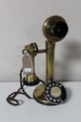 An early 20th century brass candlestick telephone