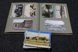 A postcard album and loose postcards,