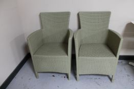 A pair of rattan garden armchairs