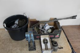 A vintage jack together with a box and a bucket containing chains, pressure gauges,