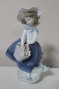 A Lladro figure of a girl with basket of flowers