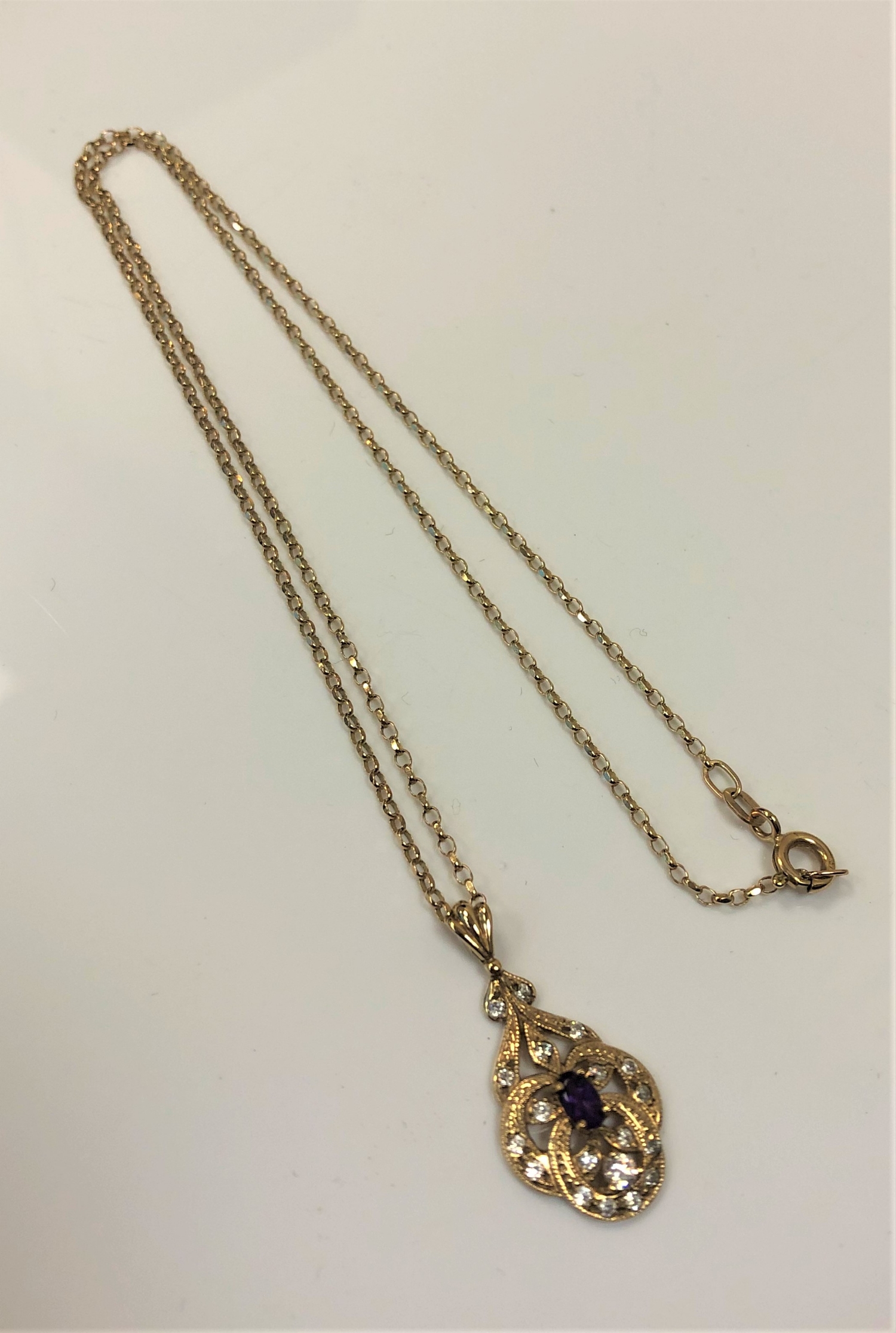 A 9ct gold diamond and amethyst set pendant on 9ct gold chain, 3.7g.