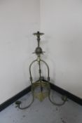 A decorative brass gas three way light fitting