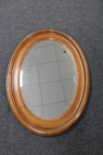 An early 20th century oak framed oval mirror