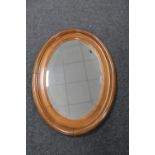 An early 20th century oak framed oval mirror