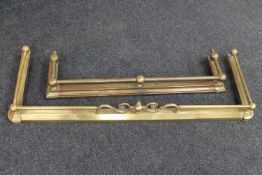 An antique brass extending fire curb and one other brass fire curb