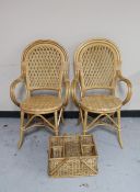 A pair of bamboo and wicker armchairs and a picnic basket