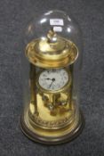 A continental brass anniversary clock under glass dome