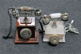 An onyx retro style telephone together with one other retro style telephone