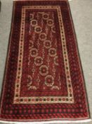 A Persian rug, on red ground,