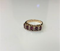 A 14ct gold five stone diamond and ruby ring, 2.9g, size K.
