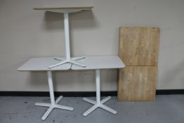 Seven Ikea pedestal cafe tables and a three table tops