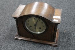 An Edwardian oak mantel clock with barley twist pillar supports