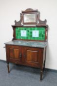 A late Victorian mahogany marble topped tile back washstand