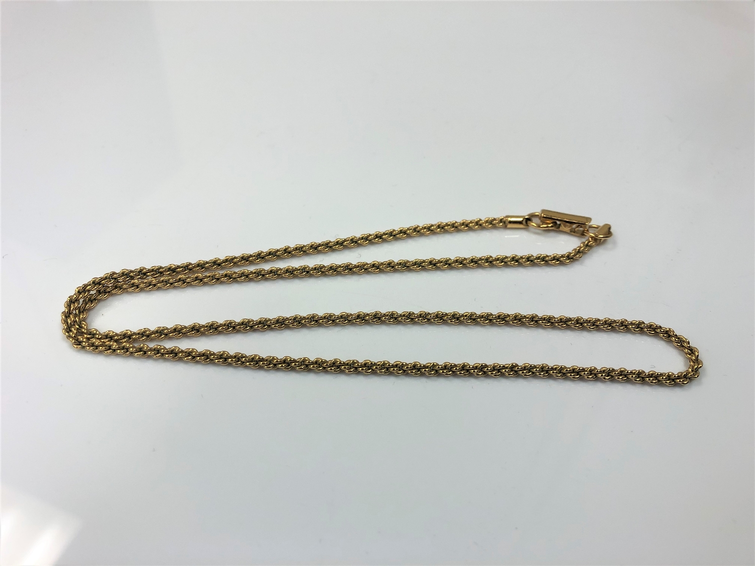 A yellow metal rope twist chain, marked 'Swarovski', 8.6g.