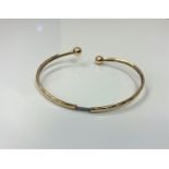 A 9ct gold sleeved expansion bangle