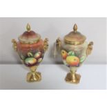 Two Coalport gilded lidded urns painted with panels of fruit by Neil Higgins and Anthony Baggott,