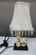 An early 20th century carved ivory table lamp depicting an antelope