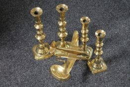 A brass aeroplane ashtray together with two pairs of brass candlesticks