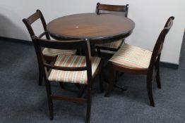 A Regency style dining table and four brass inlaid dining chairs