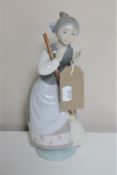 A Lladro figure - girl with broom