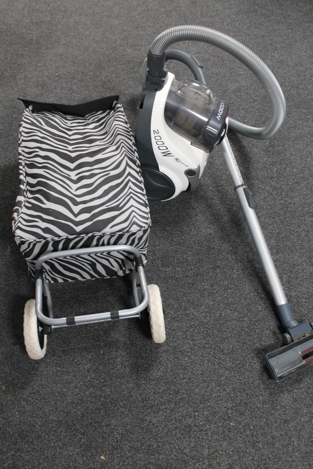 A Hoover cylinder vacuum together with an Sabichi shopping trolley