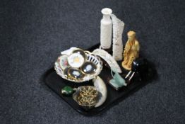 A tray of carved resin tourist china, piece of scrimshaw, carved hardwood elephant,