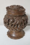 A carved Indian hardwood tobacco jar depicting elephants