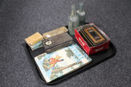 A tray containing two vintage bottles, OXO tin and cash box, transistor radio, cards, dominoes,