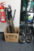 Two folding golf trolleys and a large quantity of golf clubs