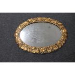 An ornate gilt framed chalk mirror