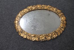 An ornate gilt framed chalk mirror