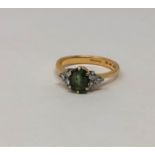 A demantoid garnet and diamond ring, size R CONDITION REPORT: 5.