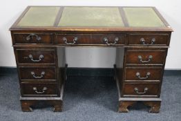 A mahogany twin pedestal writing desk fitted nine drawers,