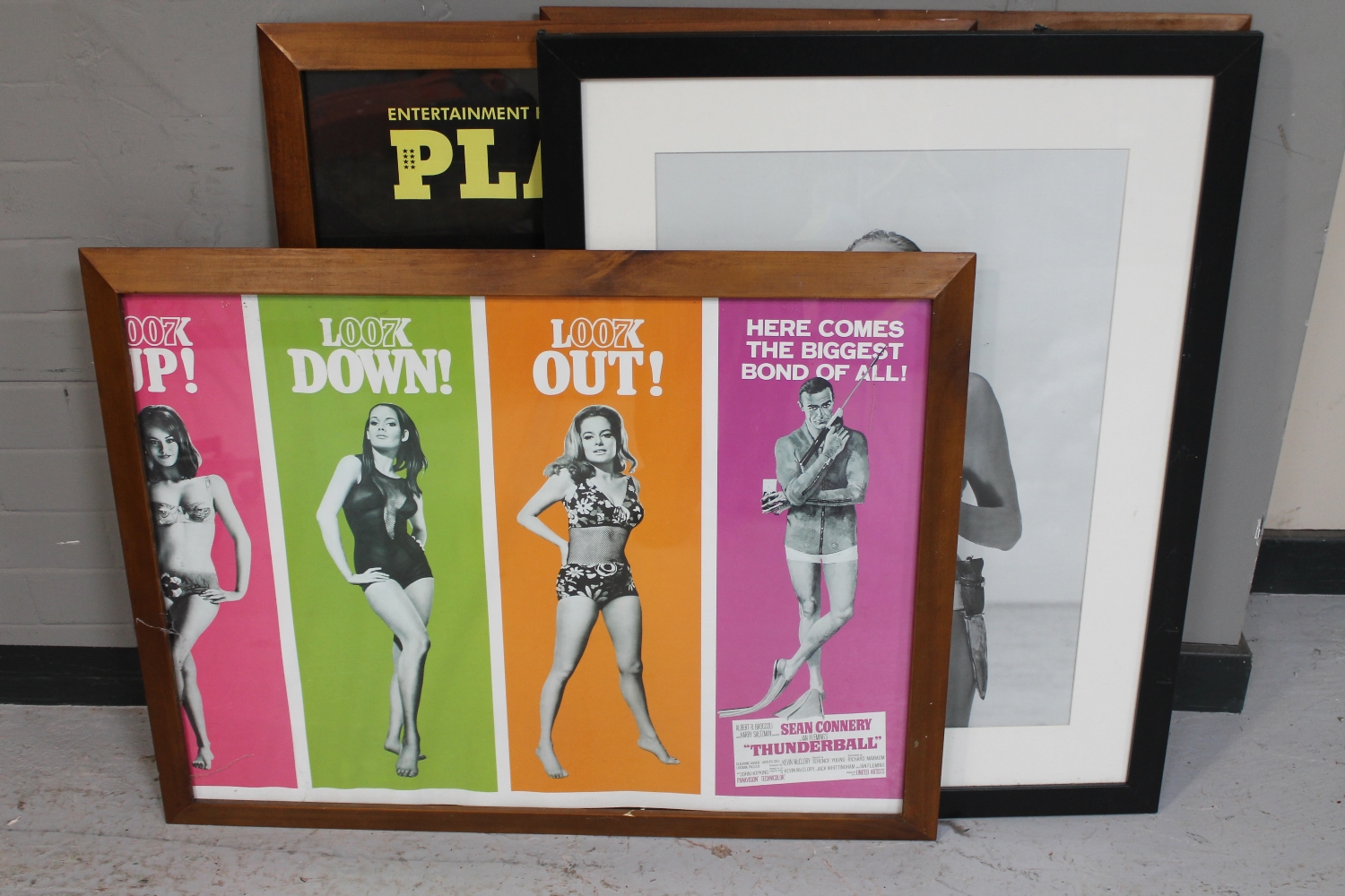 Two framed Playboy posters together with a further framed James Bond Thunderball poster and a