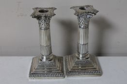 A pair of silver Corinthian column candlesticks, London 1906, height 15.