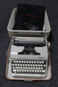 A cased Olympia typewriter and a Halina camera