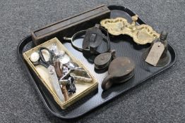 A tray of a bronze bell, vintage wooden domino box, stirrup, two vintage pulleys,