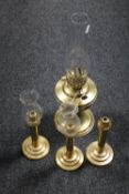 A Duplex brass oil lamp with glass chimney, together with three brass candlesticks,