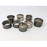 Eight assorted silver serviette rings.