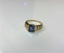 A 14ct gold diamond ring, set with a square cut blue stone (probably tanzanite), 4.5g, size M/N.