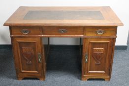 An Edwardian mahogany Arts and Crafts desk
