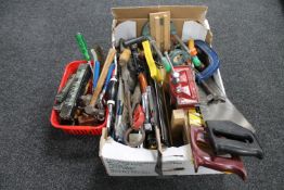 A box and a basket containing assorted vintage and later hand tools, saws, vices,
