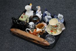 A tray of china : copper lustre jug, two Royal Doulton tea cups and saucers, figures, cow creamer,