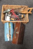 A pine box together with a wicker basket containing hand saws and power tools,