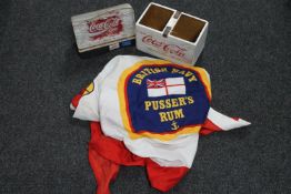 A British Navy Pusser's rum flag together with two Coca Cola advertising items.