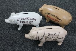 Three cast iron pig money boxes