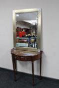 A contemporary gilt framed bevelled edge mirror together with a mahogany shaped hall table fitted