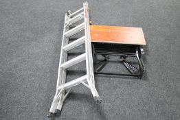 A set of folding aluminium ladders together with a Black & Decker workmate